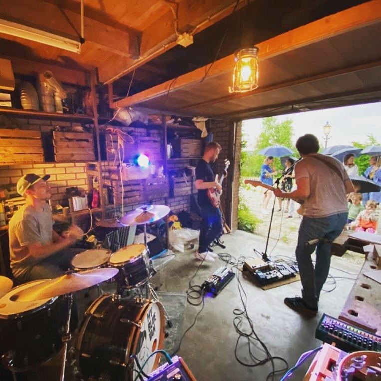 Rehearsing in a wooden garage with the door open